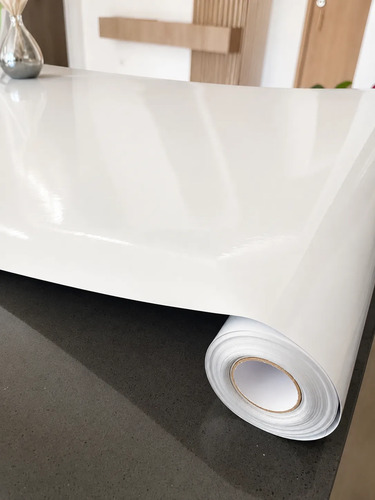 Rollo de papel autoadhesivo blanco de 80cm x 10m, vista superior mostrando superficie lisa y rollo enrollado